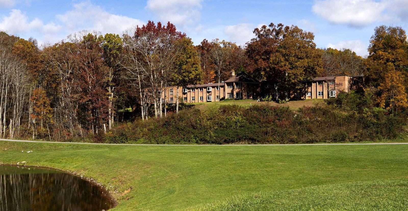 Hillside campus overlooking lawn and water at GlenWood Park Princeton