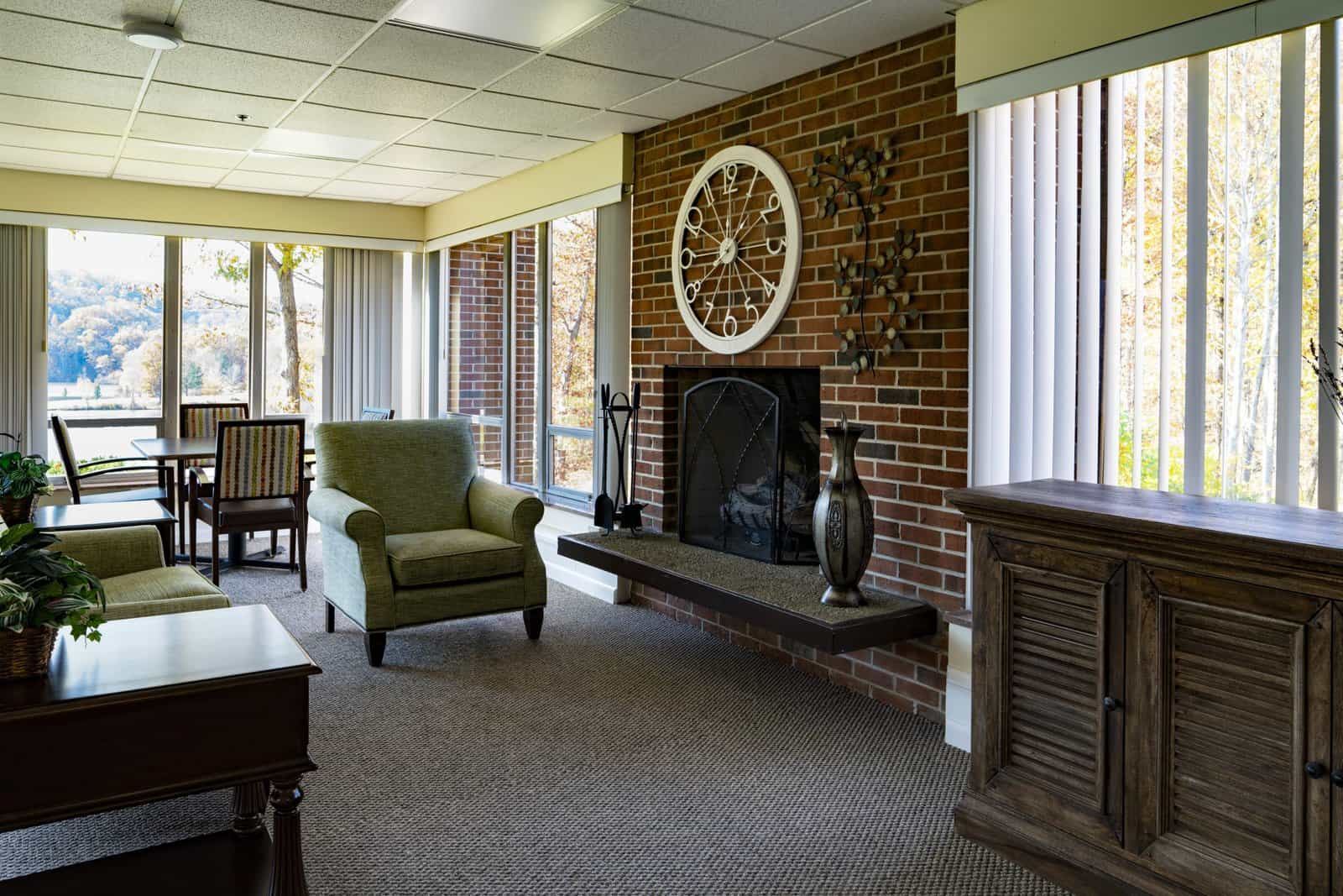 Sunroom with fireplace and lake views at GlenWood Park